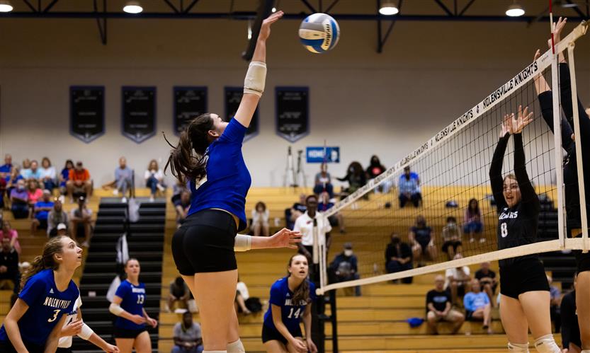 High school students play volleyball